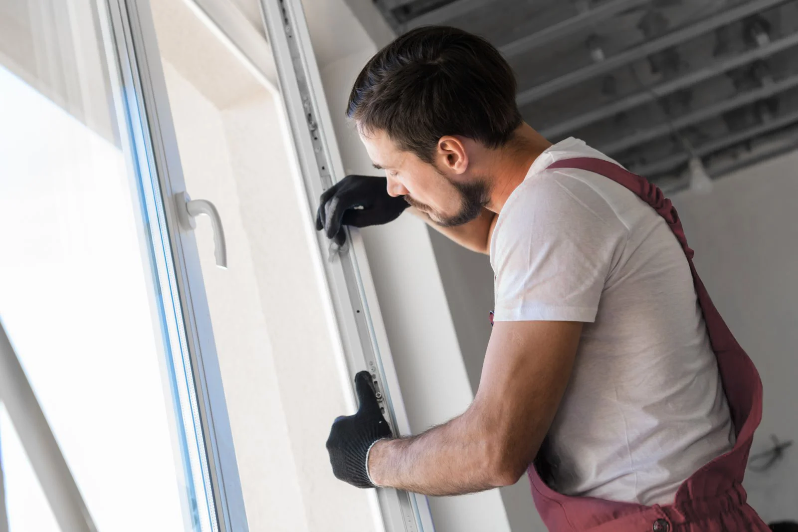 Technician cleaning and lubricating window track mechanism